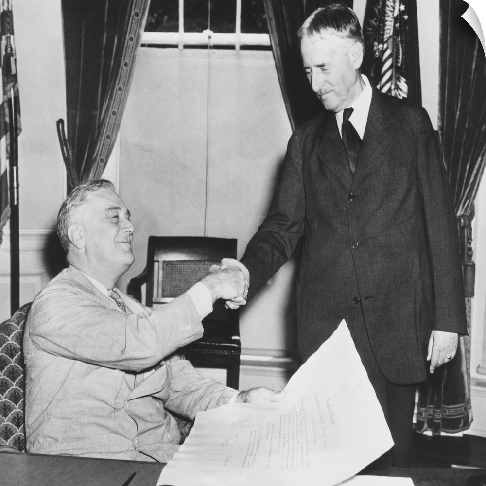 President Franklin Roosevelt shaking hands with his new Secretary of War, Republican Henry Stimson. July 10, 1940. FDR est...