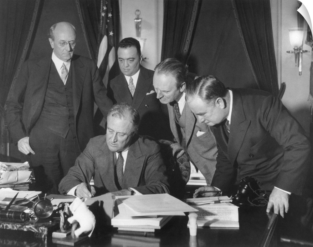 President Franklin Roosevelt signing the 1934 crime bill into law. Looking on from left: Attorney General Homer Cummings; ...