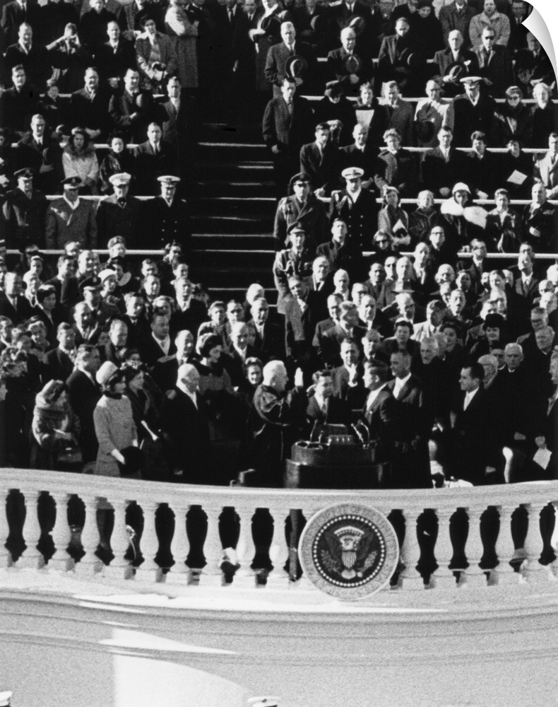 President John Kennedy takes the oath of office administered by Chief Justice Earl Warren. Jan. 20, 1961.