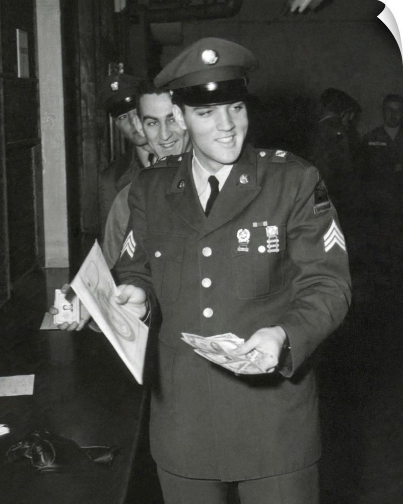 Sgt. Elvis A. Presley, 32nd Armored, 3rd Armored Div. collecting his last pay as he re-enters civilian life. March 5, 1960.