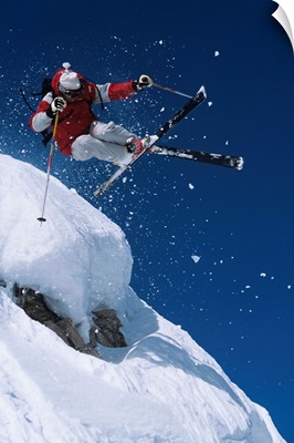 Skier In Mid-Air Above Snow On Ski Slopes
