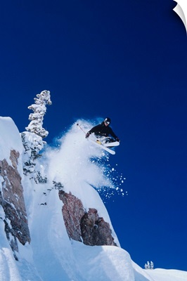 Skier Jumping From Mountain Ledge