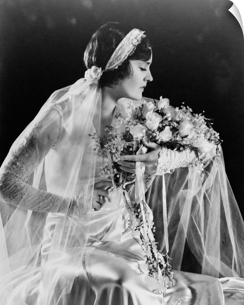 Woman in wedding gown, holding flowers, 1932.