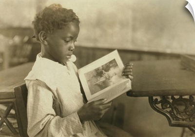 Young girl reading an illustrated book