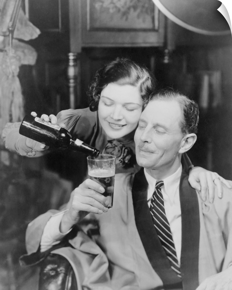 Young woman pouring beer into a man's glass, 1933. Photo was created in response to the legalization of beer with an alcoh...