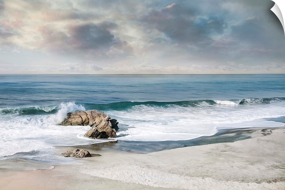 Landscape photograph of waves crashing onto a rock on the sandy shore.