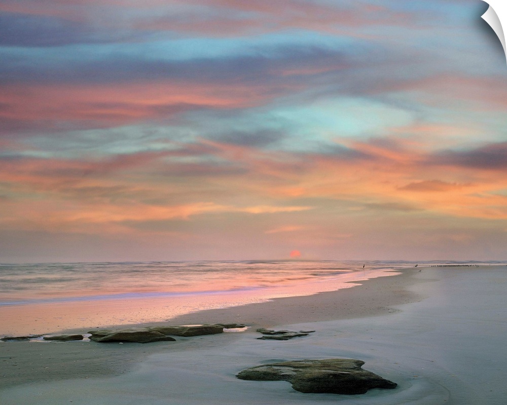 Landscape photograph of a colorful sunset on Matanzas Beach, FL.