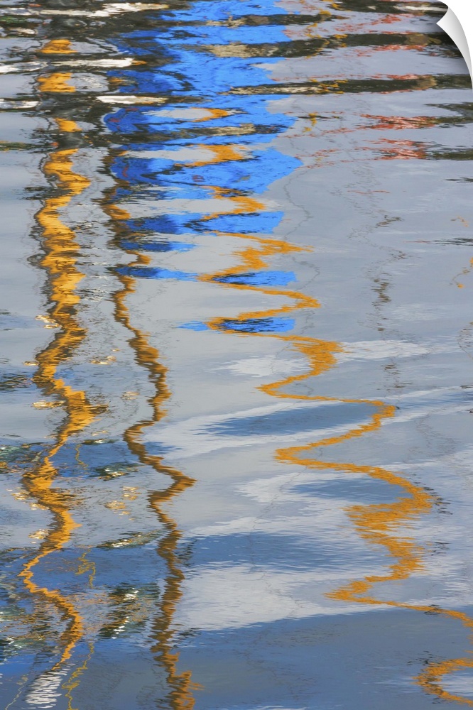 Reflection of a boat on rippling water, creating an abstract image.