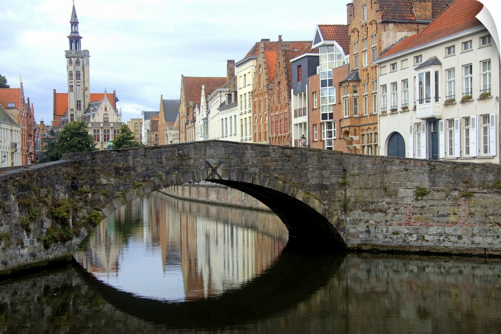 Photograph of an old stone bridge in Belgium over a river.