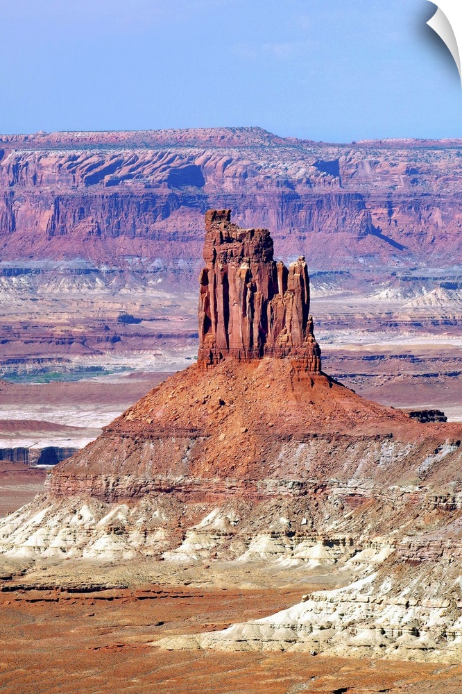A tall rock formation in the desert landscape of Utah.