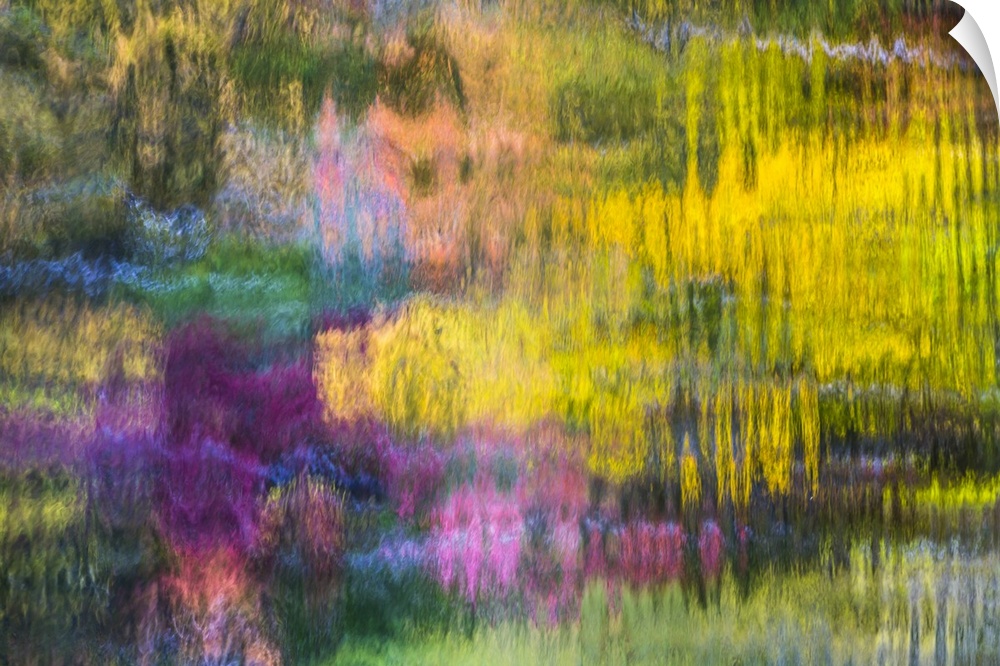 Reflections of a colorful forest in rippling water, creating an abstract image.