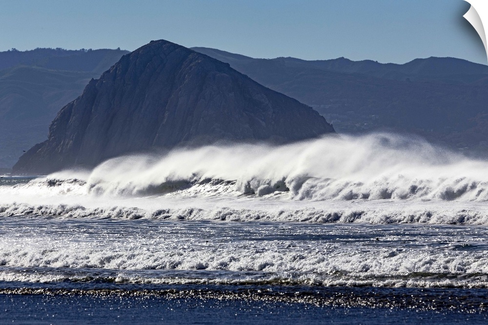 Photograph of big dramatic surf crashing over rocks in Morro Bay, California.