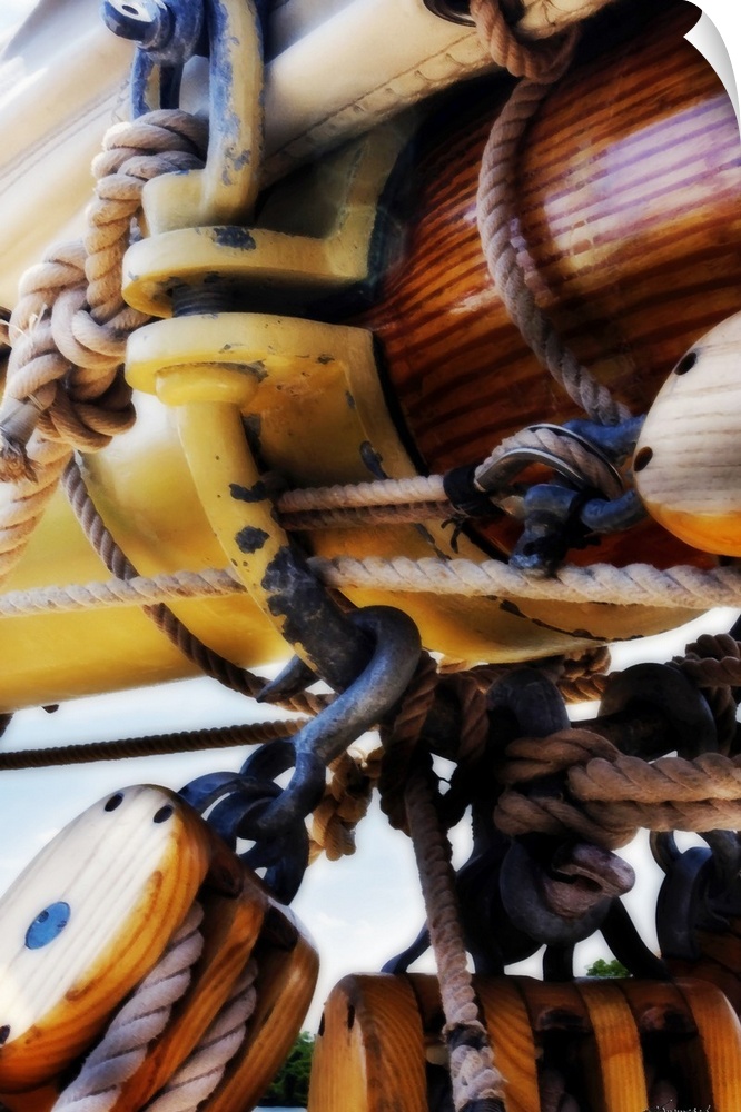 Up-close photograph of ropes, knots, and pulley system on a boat.
