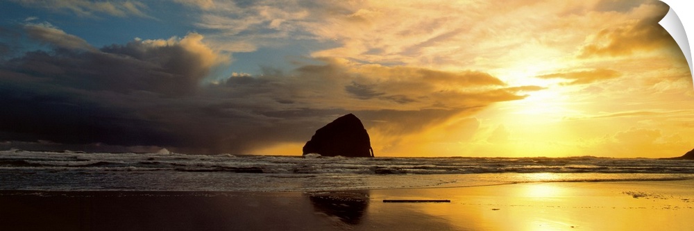 Sea stacks on the beach silhouetted at sunset, Pacific City, Oregon.