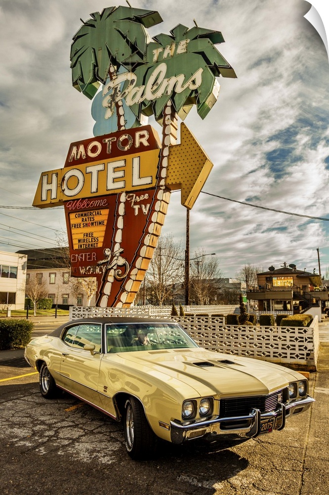 HDR photo of a vintage car parked in front of a motel with a retro neon sign.