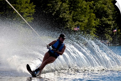 A female water skier rips a turn