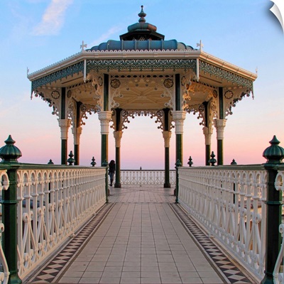 A lone figure and an almost symmetrical shot of an ornate seaside bandstand.
