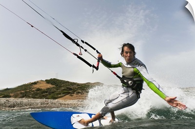 a man kite surfing off the coast of parque natural del estrecho