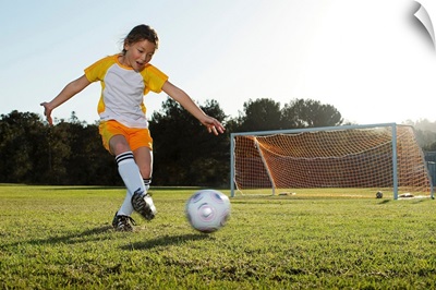 A young girl playing soccer on a soccer field in Los Angeles, California.