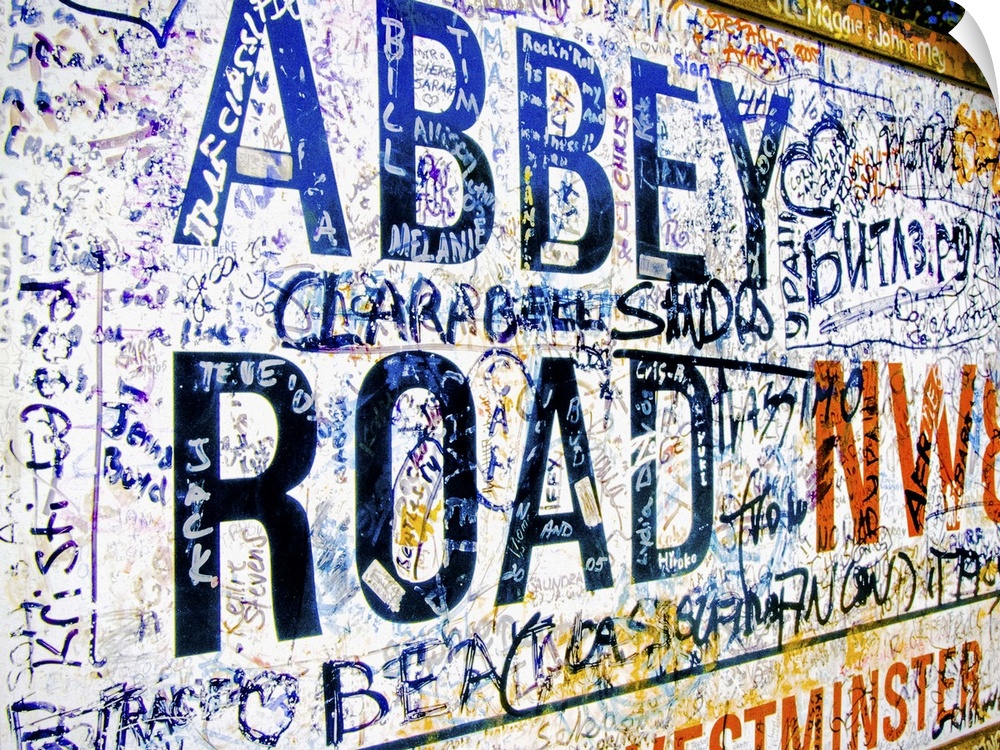 Famous Abbey Road road sign covered with grafitti from Beatle fans