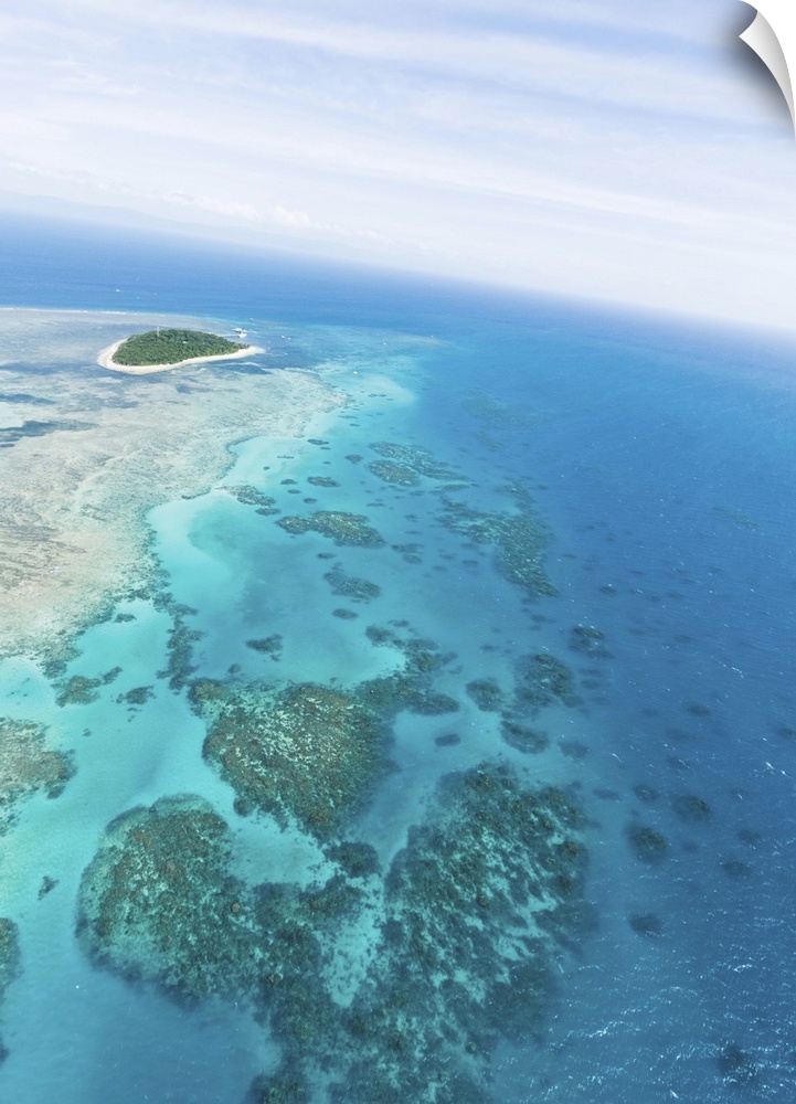 Clear blue tropical water, Green Island and Great Barrier Reef from above by helicopter