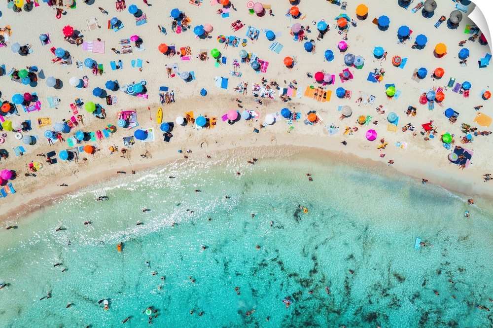 Aerial view of sandy beach with colorful umbrellas, swimming people in sea bay with transparent blue water in sunny mornin...
