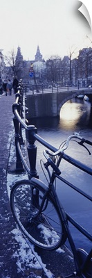 Amsterdam, Holland - bicycle standing at railings on canal bank