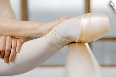 Ballerina stretching on barre