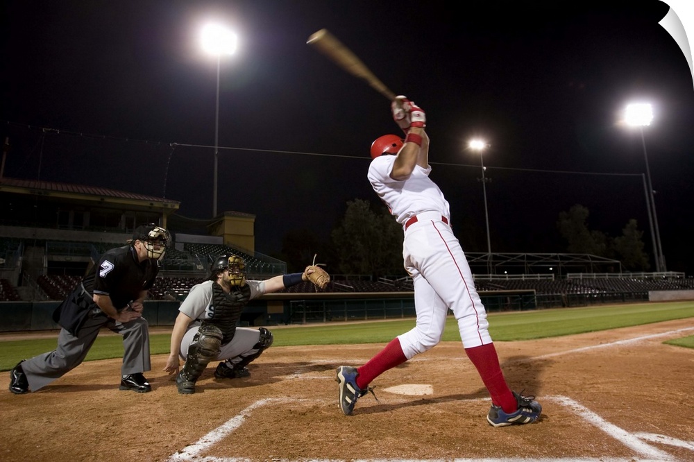 USA, California, San Bernardino, baseball players with batter swinging