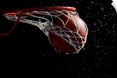 Basketball going through hoop