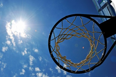 Basketball Hoop and the Sun, against blue sky