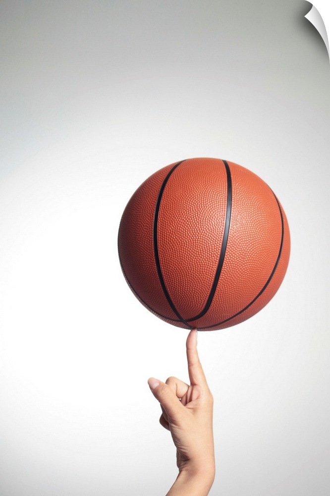 Basketball on index finger,hands close-up
