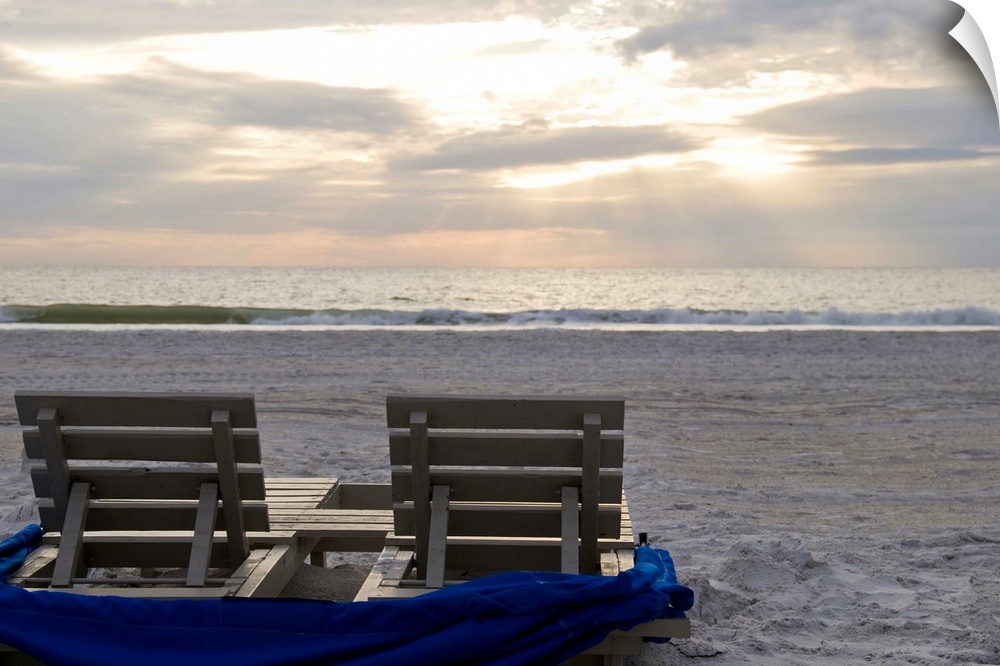 Beach chairs on St. Pete's beach at sunset.