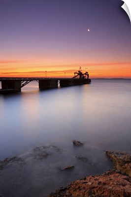 Beautiful beach and bridge in Spain at sunset.