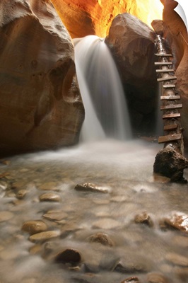 Beautiful waterfall with pebbles on foreground.