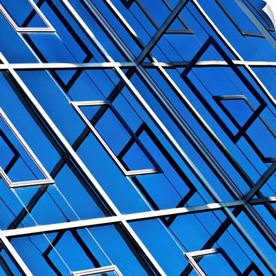 Blue, abstract and geometric reflection on  facade of modern building.
