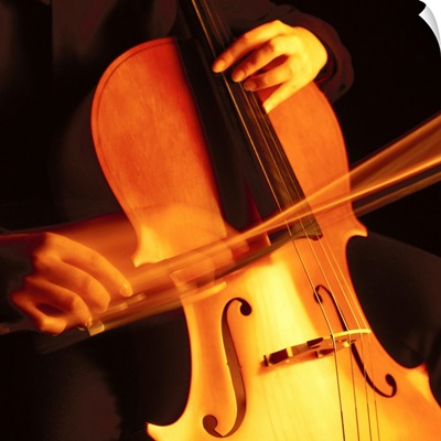 blurred shot of a person playing the cello