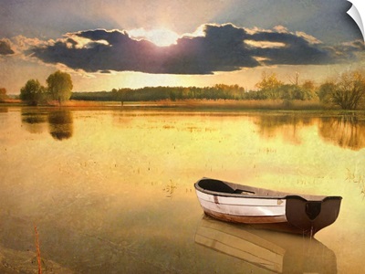 Boat in lake at sunset.