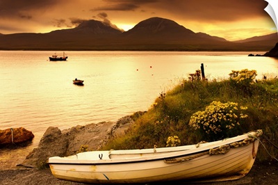 Boat on the shore at sunset, Island of Islay, Scotland