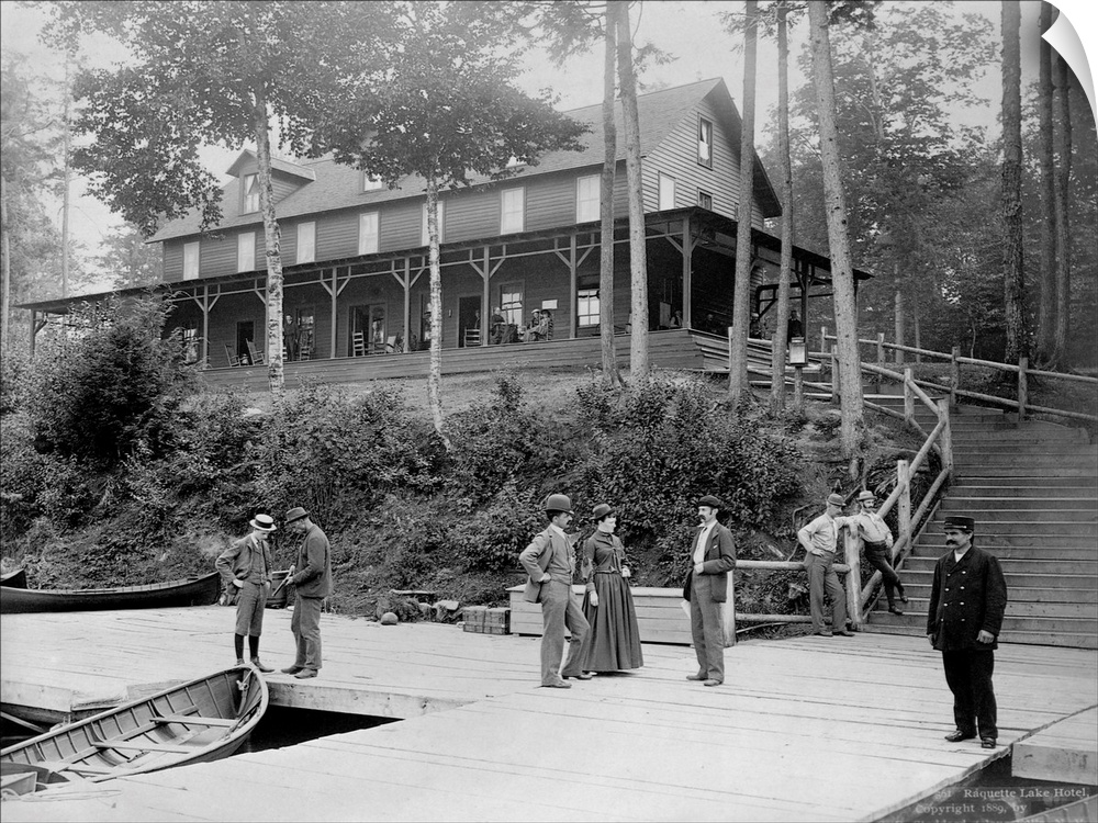 Boaters vacationing in the Adirondack Mountains talk on the pier at the Raquette Lake Hotel. Ca. 1889. | Location: Raquett...