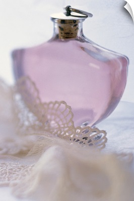 Bottle of perfume with lace