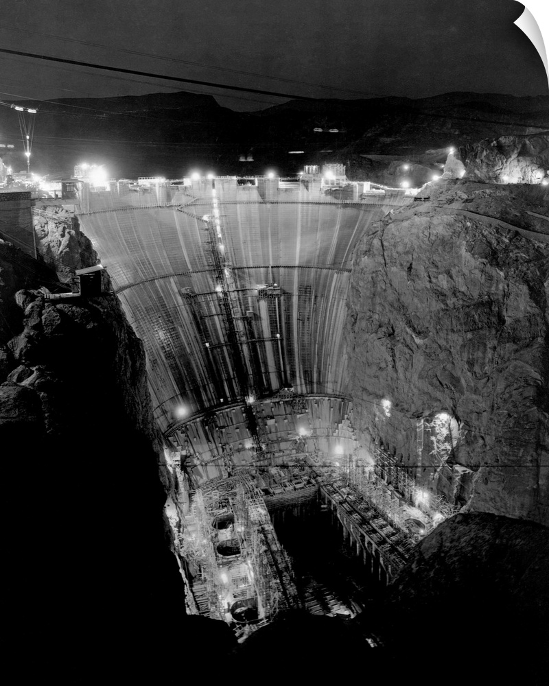 Floodlights illuminate Boulder Dam at night during construction. Boulder Dam, now called Hoover Dam is one of the world's ...