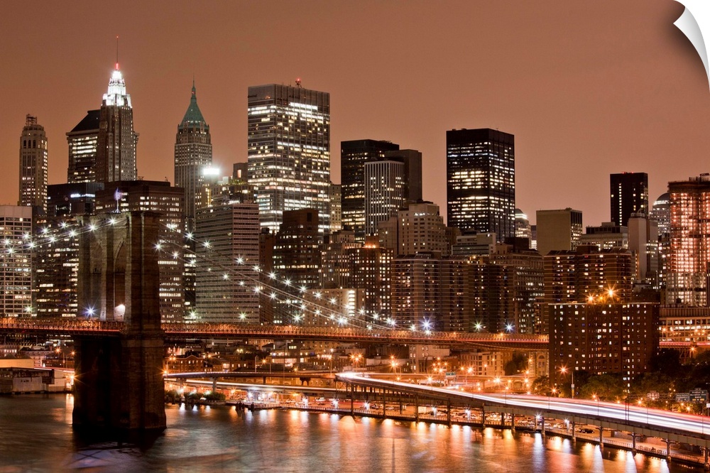 USA, New York, Brooklyn, Brooklyn Bridge at night and East River with Lower Manhattan skyline glowing in distance