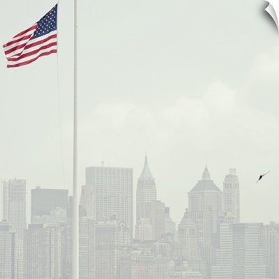 Buildings of Manhattan with United States flag flying in foreground.