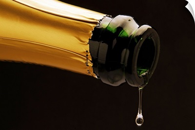 Champagne drop dripping from bottle