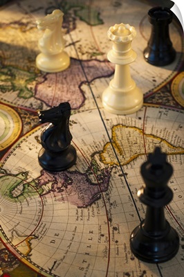 Chess pieces on old world map