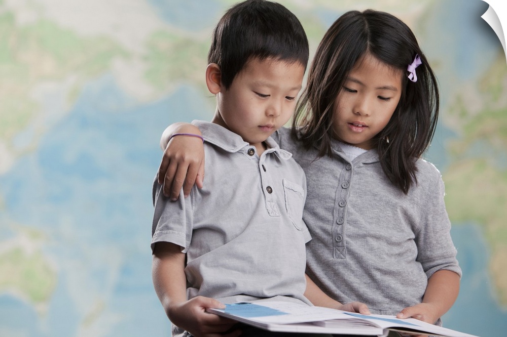Korean children reading book near map