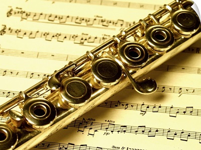 Close-up of a flute on a sheet music
