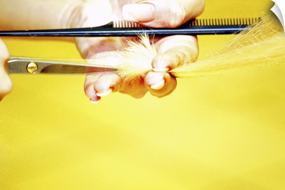 Close-up of a hairdresser's hand cutting a woman's hair