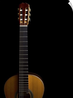 Close-up of acoustic guitar on black